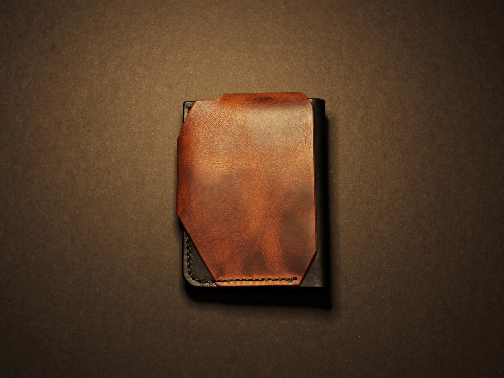 Brown leather wallet on a black background