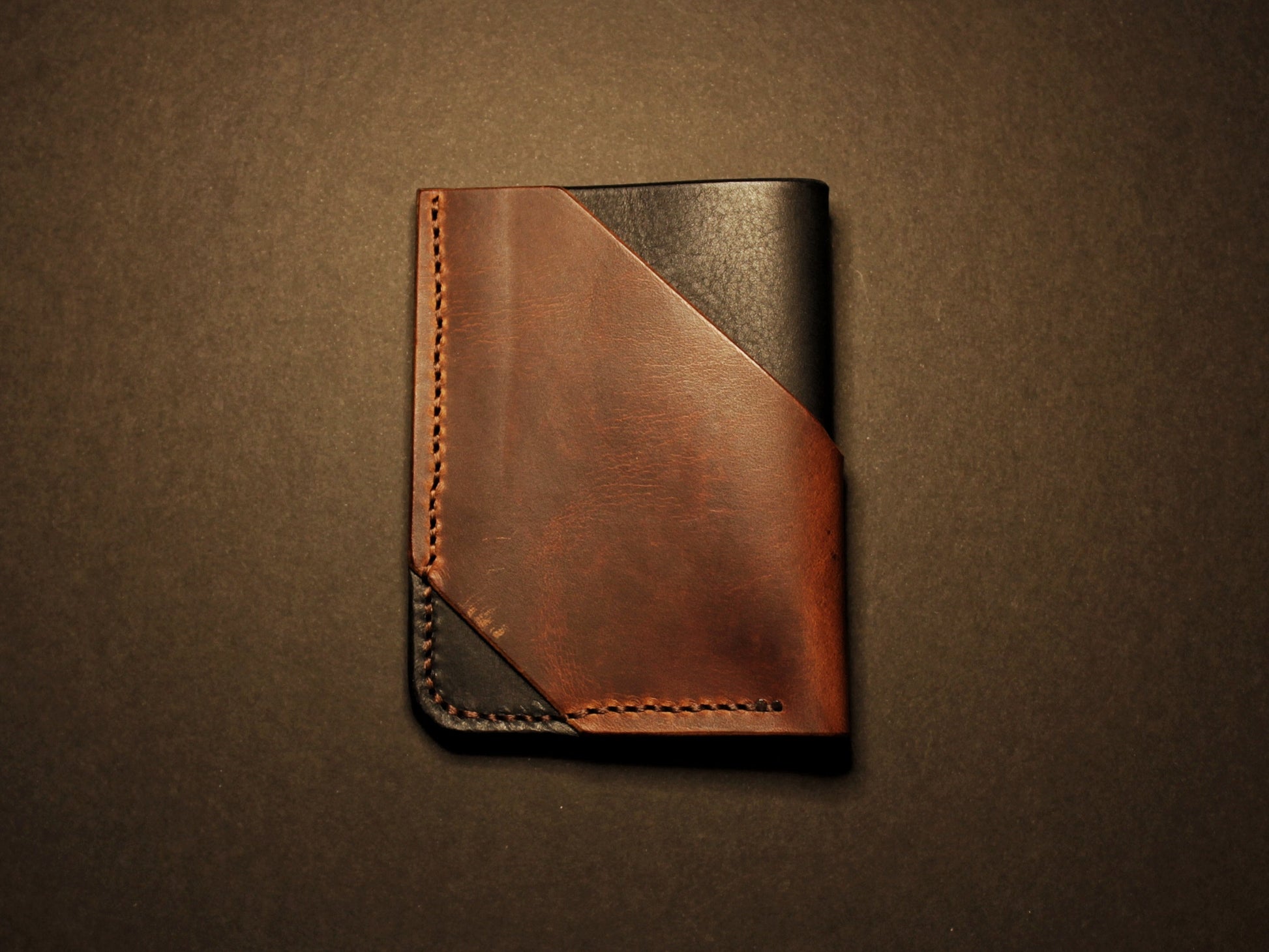 Brown leather wallet on a dark brown background