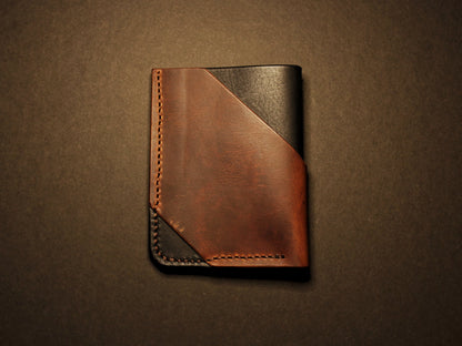 Brown leather wallet on a dark brown background